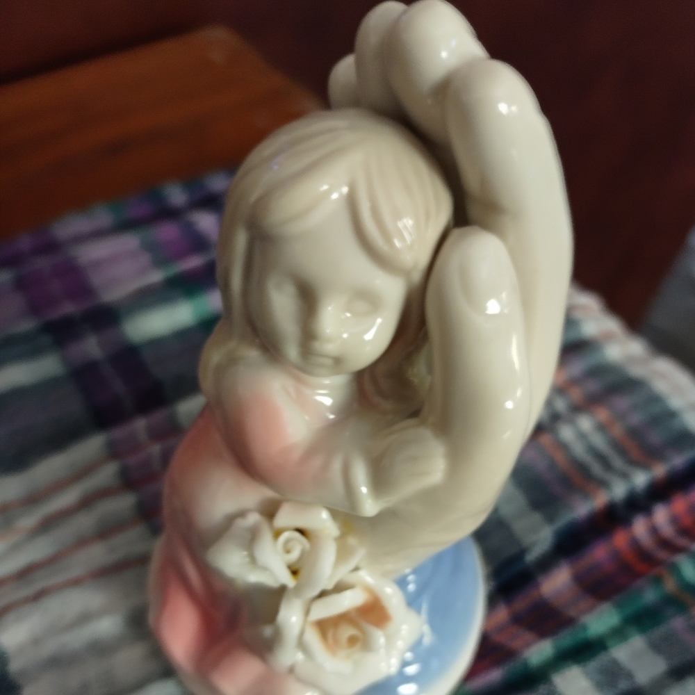 Beautiful ceramic little girl in hand